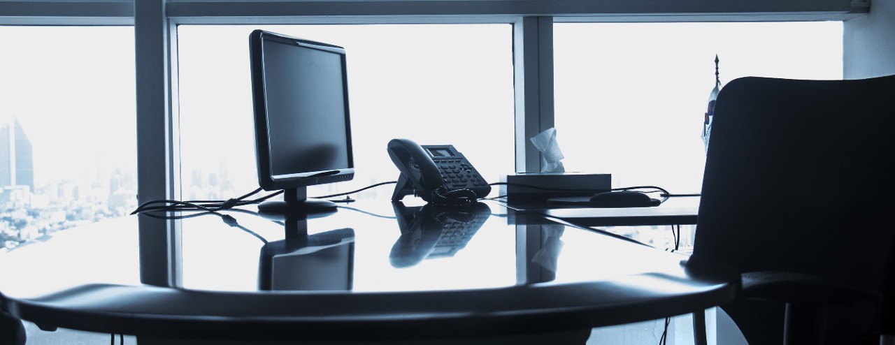 Computer and phone at a business desk